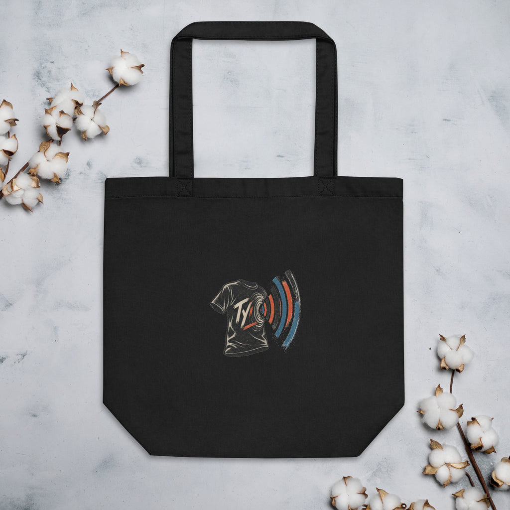 Front of black TYV Core Mark tote in a flat lay beside cotton stems