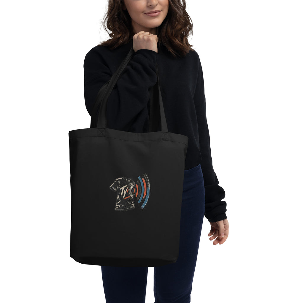 Model carrying the black organic cotton tote with the TYV front print visible