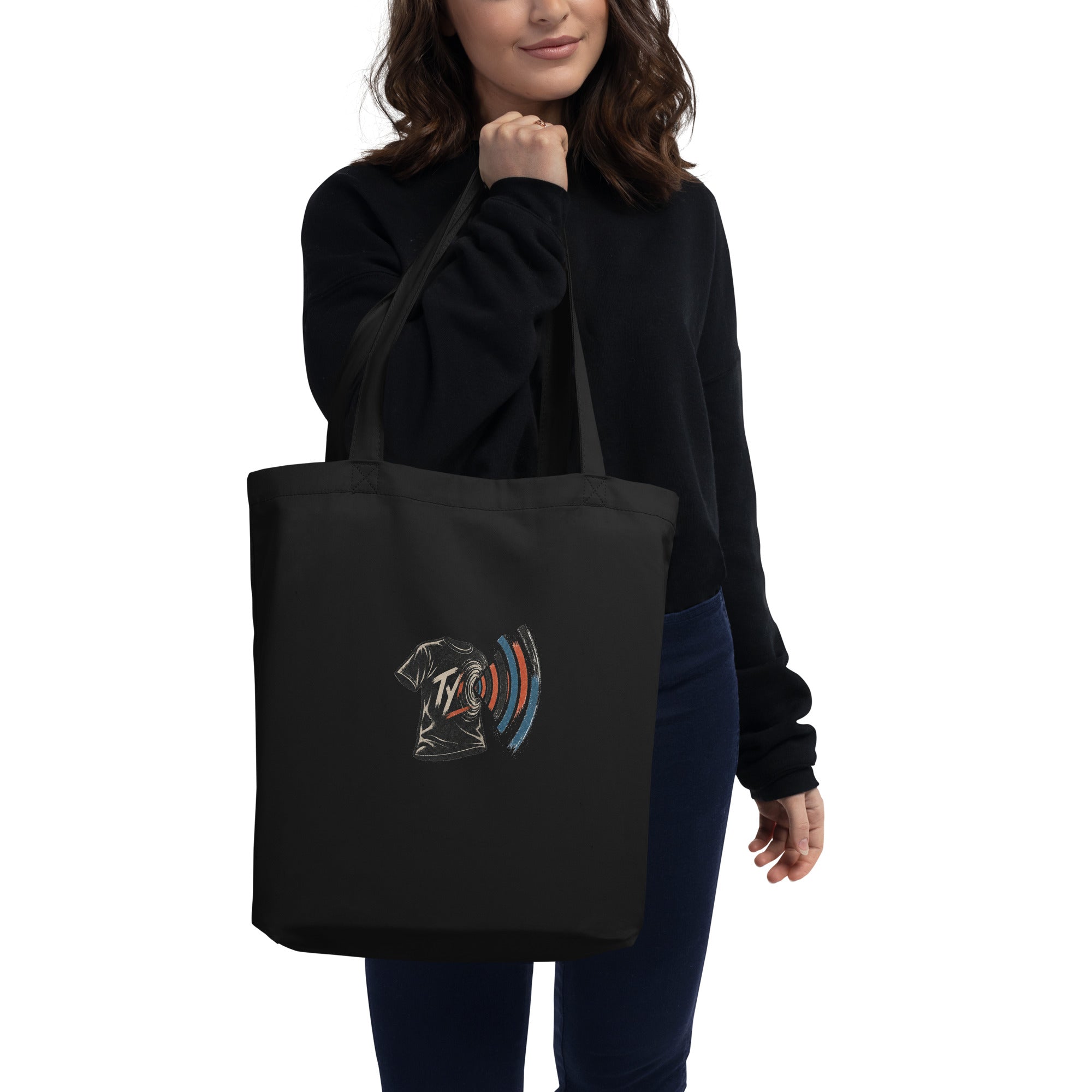 Model carrying the black organic cotton tote with the TYV front print visible